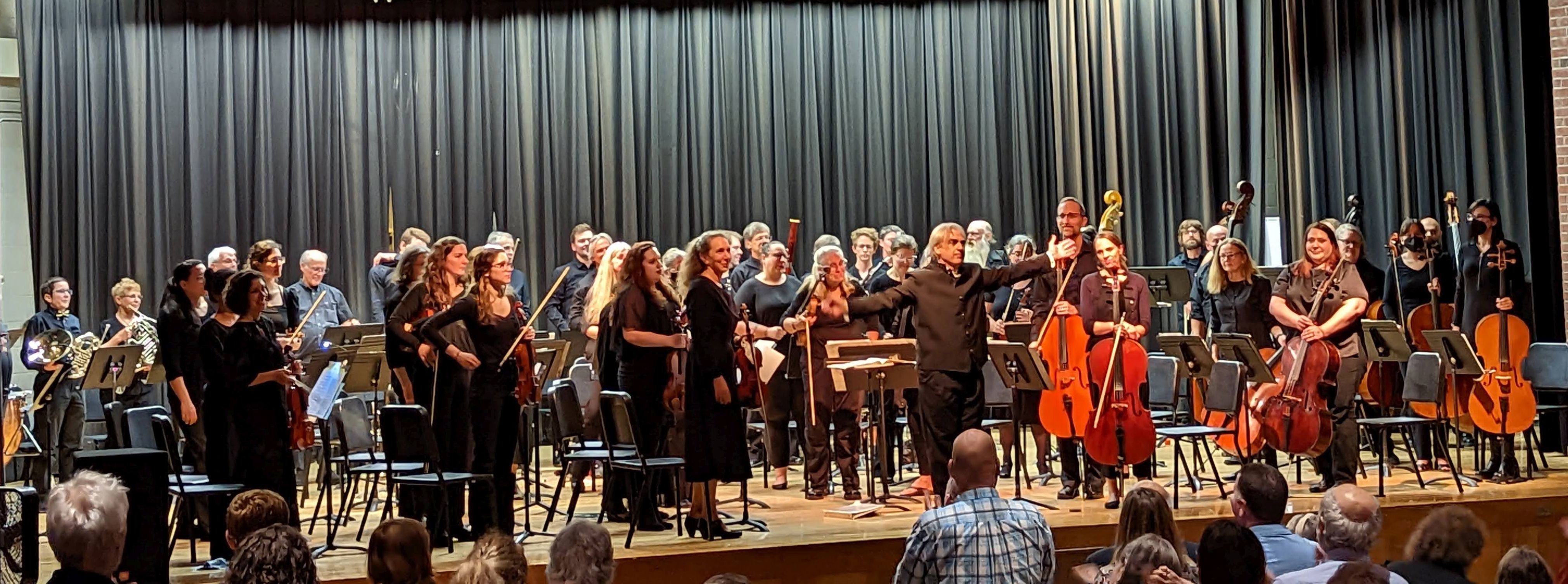 The orchestra taking a bow after the concert on the stage at Hunt Middle School