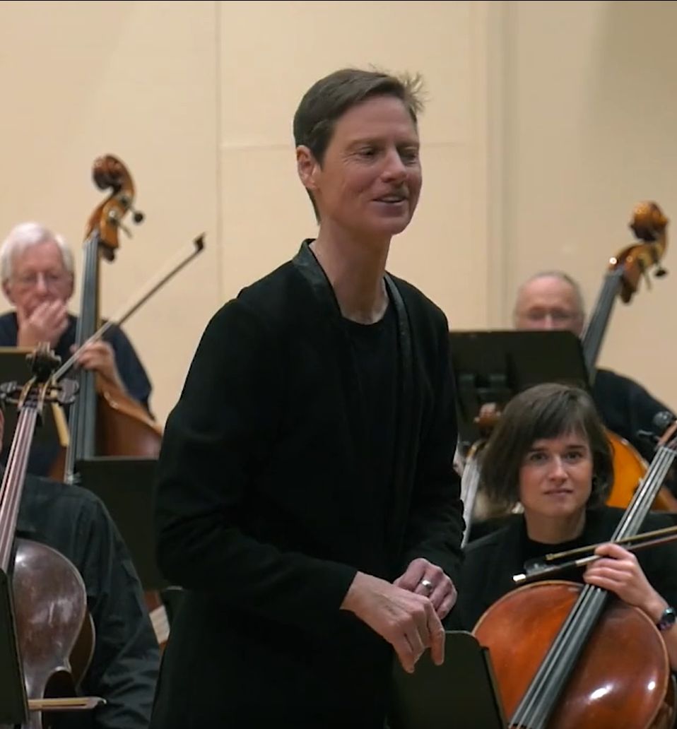 Kim Diehnelt addressing the audience at a concert